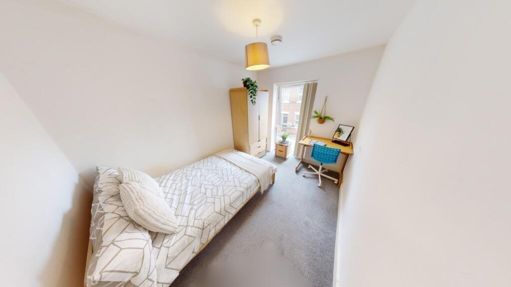 Bright and cozy single bedroom featuring a comf...