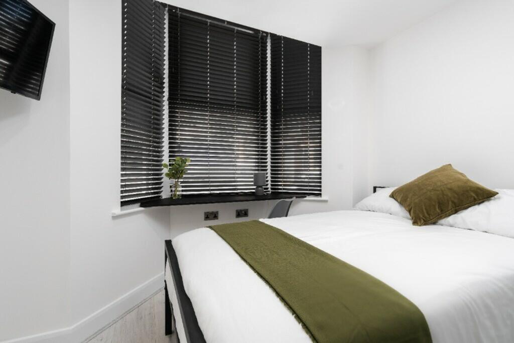 A stylish and inviting double bedroom featuring...