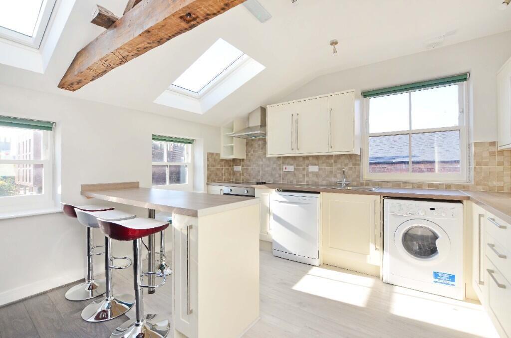 Bright and modern kitchen featuring a breakfast...