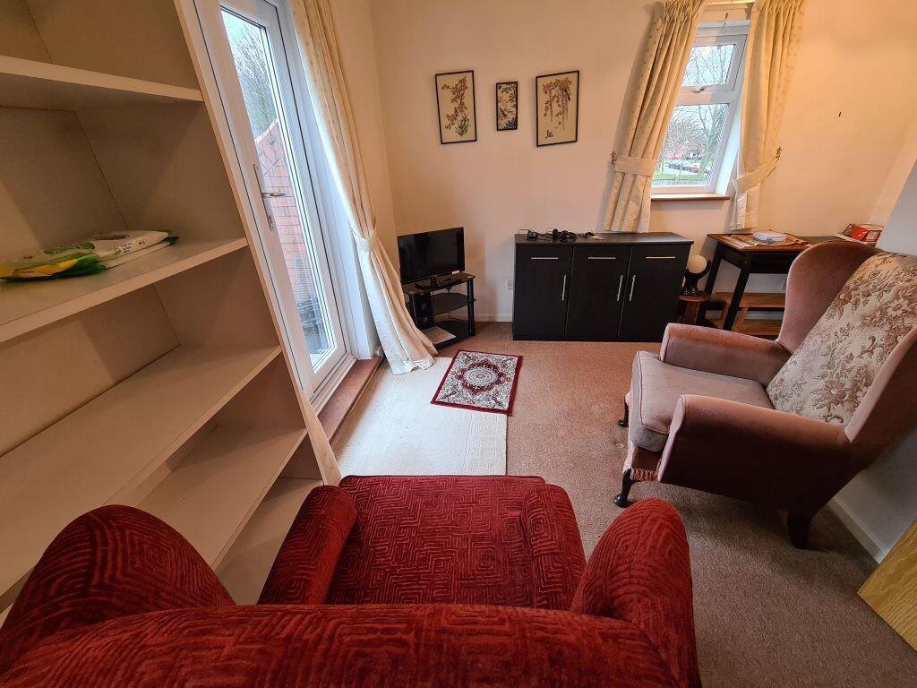 A cozy living room featuring comfortable armcha...