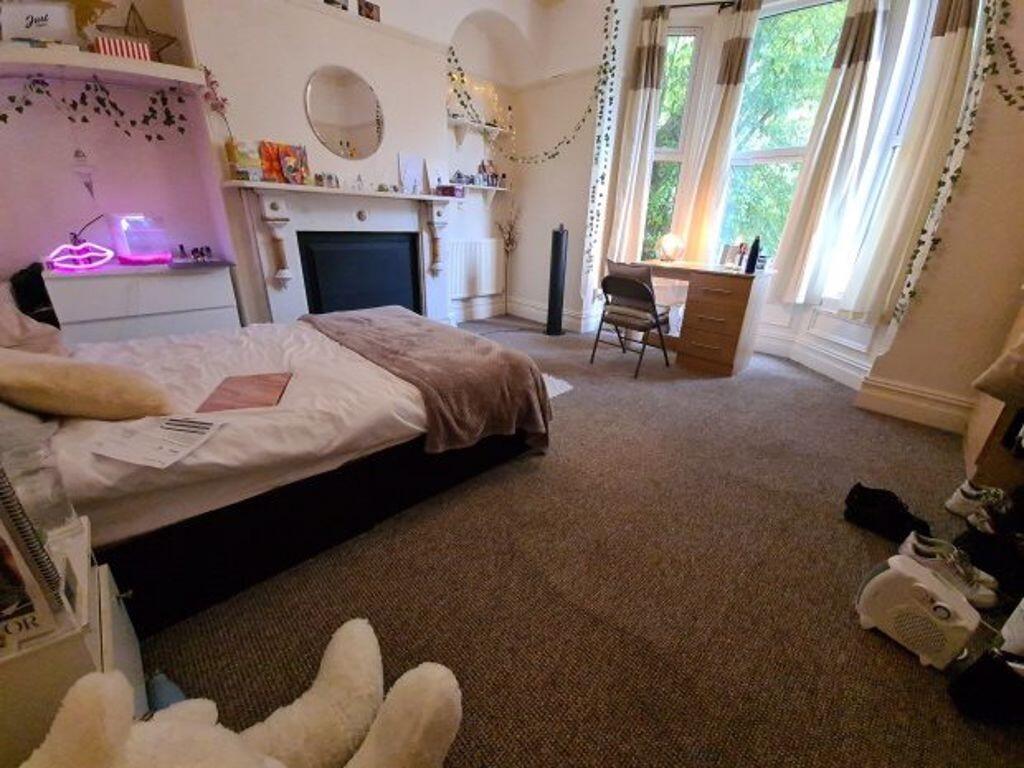 Spacious and well-lit master bedroom featuring ...