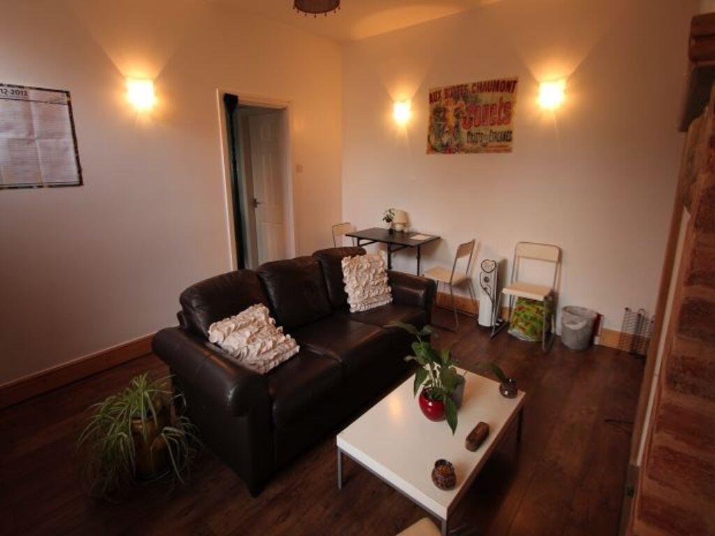 Cozy living room featuring a comfortable leathe...