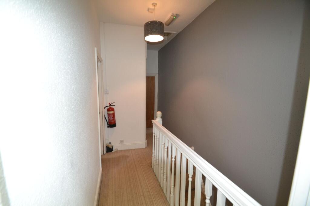 A clean, well-maintained hallway with a modern ...
