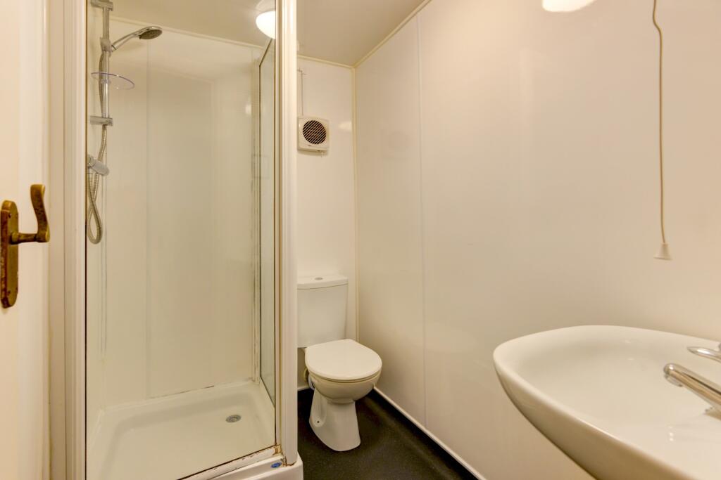 A clean, modern bathroom featuring a spacious s...