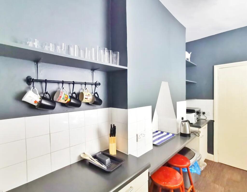 Compact and tidy kitchen area featuring a sleek...
