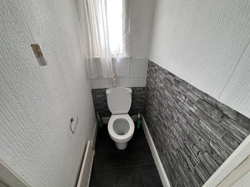 Bright and clean single toilet room featuring a...