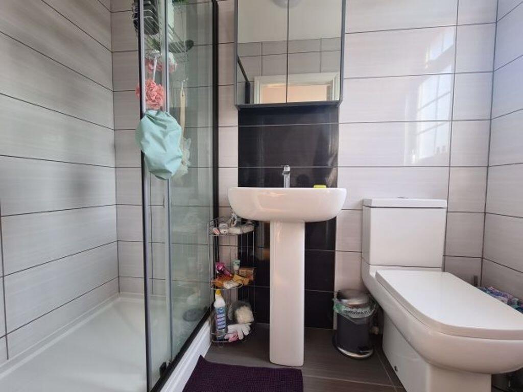 A clean and modern bathroom with a shower enclo...