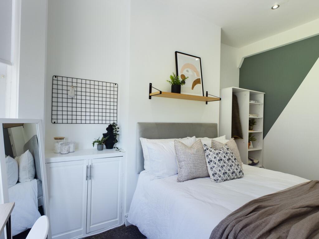 A stylish and inviting double bedroom with ampl...