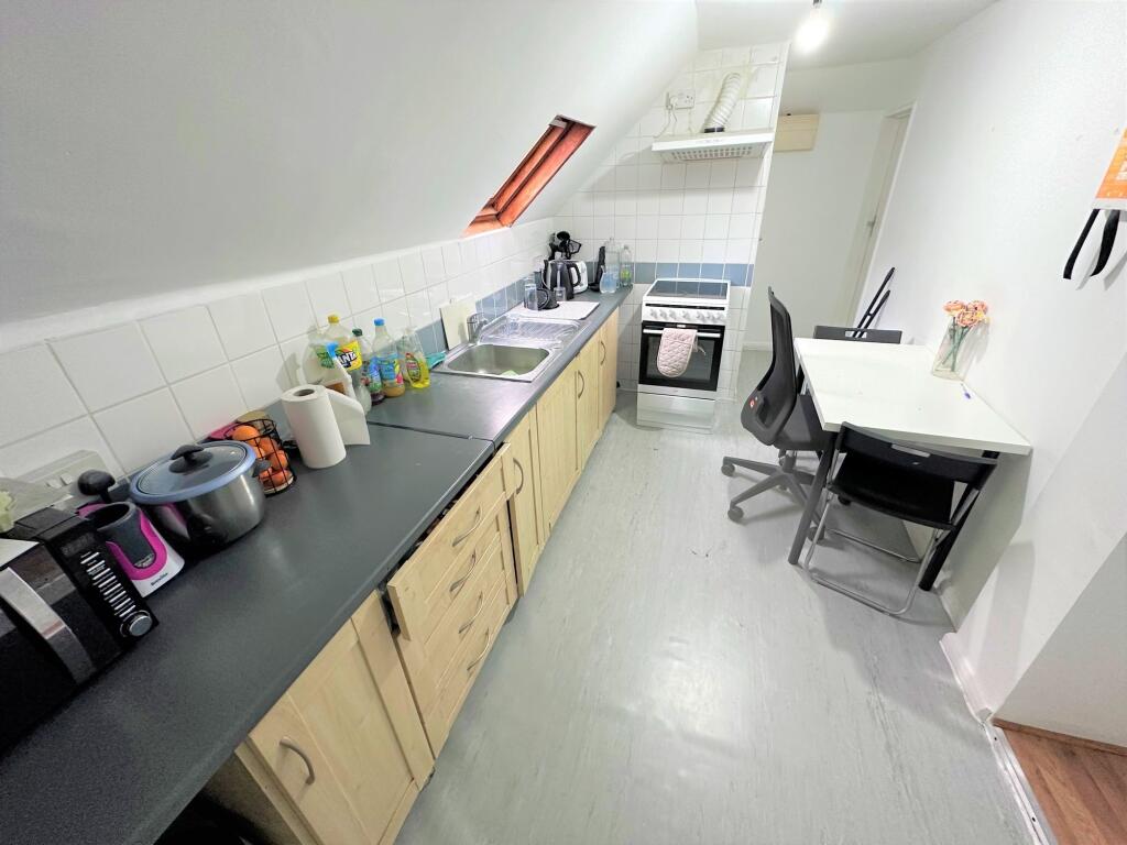 A neat and functional kitchen featuring a long ...