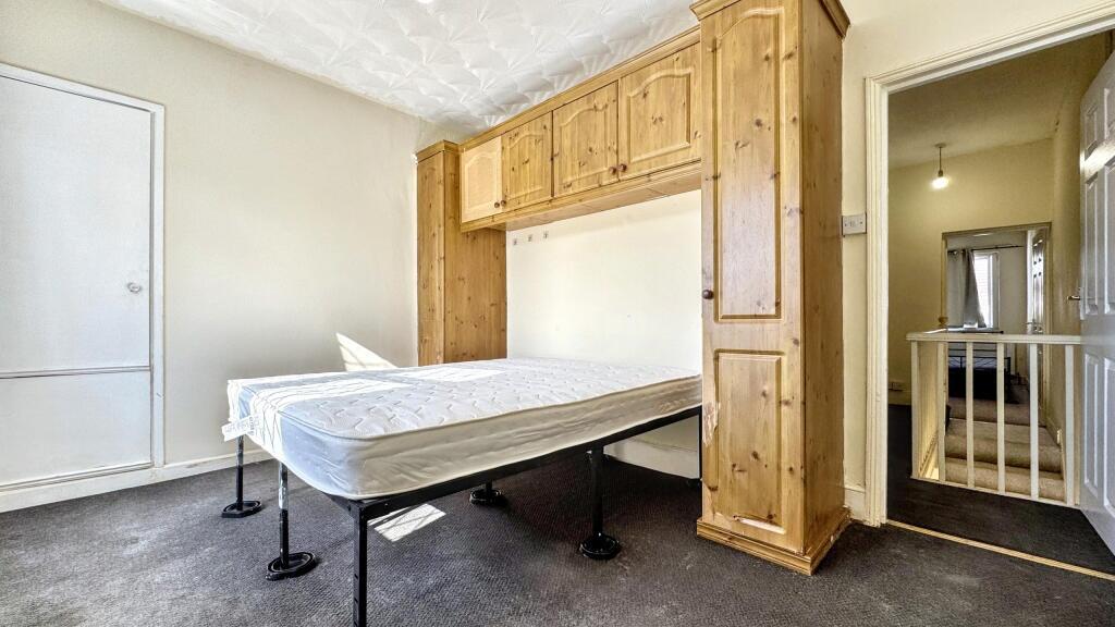 Bright double bedroom featuring a large built-i...