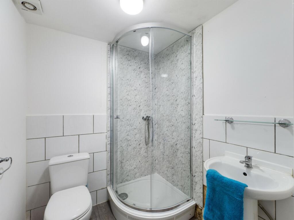 A modern bathroom featuring a stylish shower an...