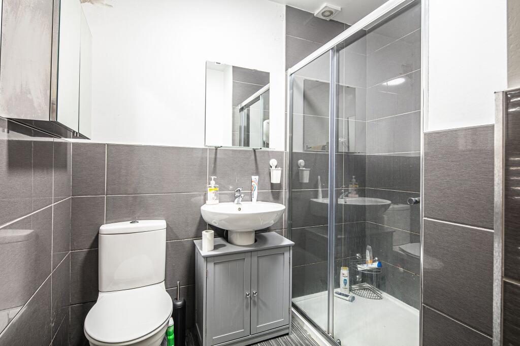 Modern bathroom featuring a white toilet, a sty...