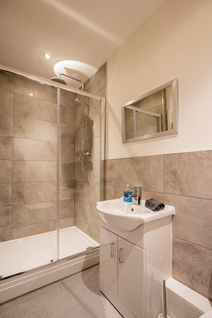 A modern bathroom featuring a walk-in shower wi...