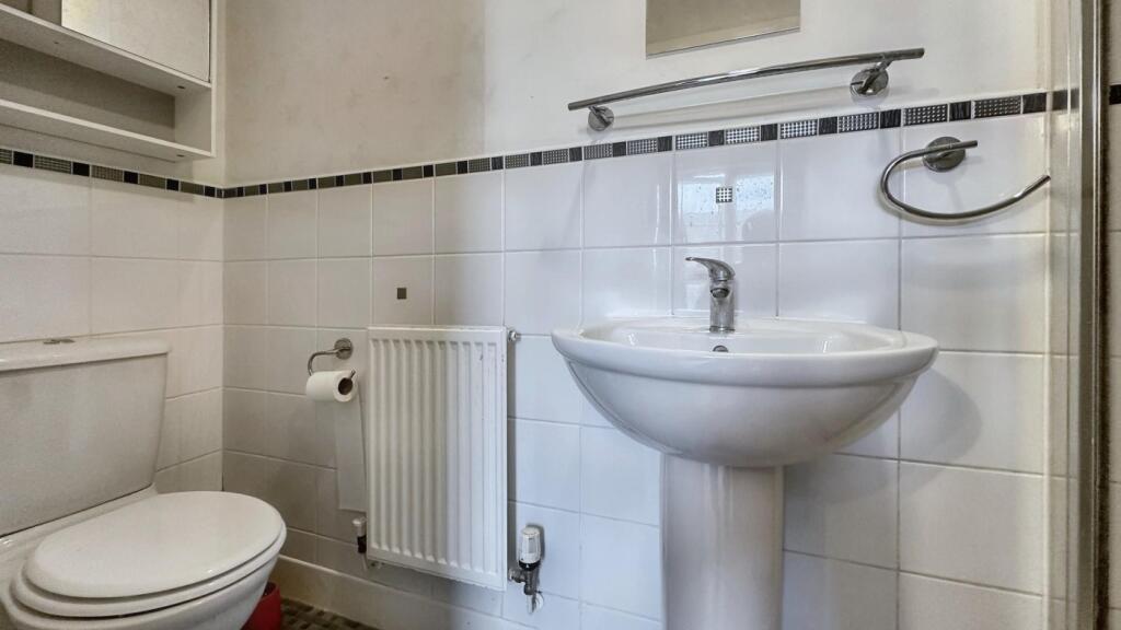A clean bathroom featuring a shower, modern fix...