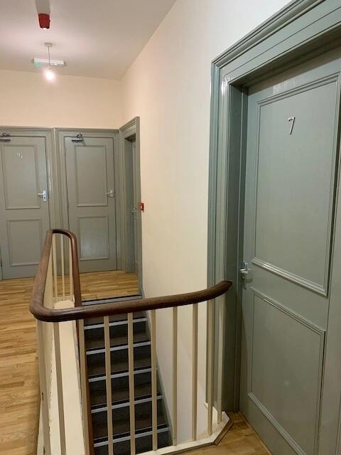 Well-maintained indoor staircase area with ligh...