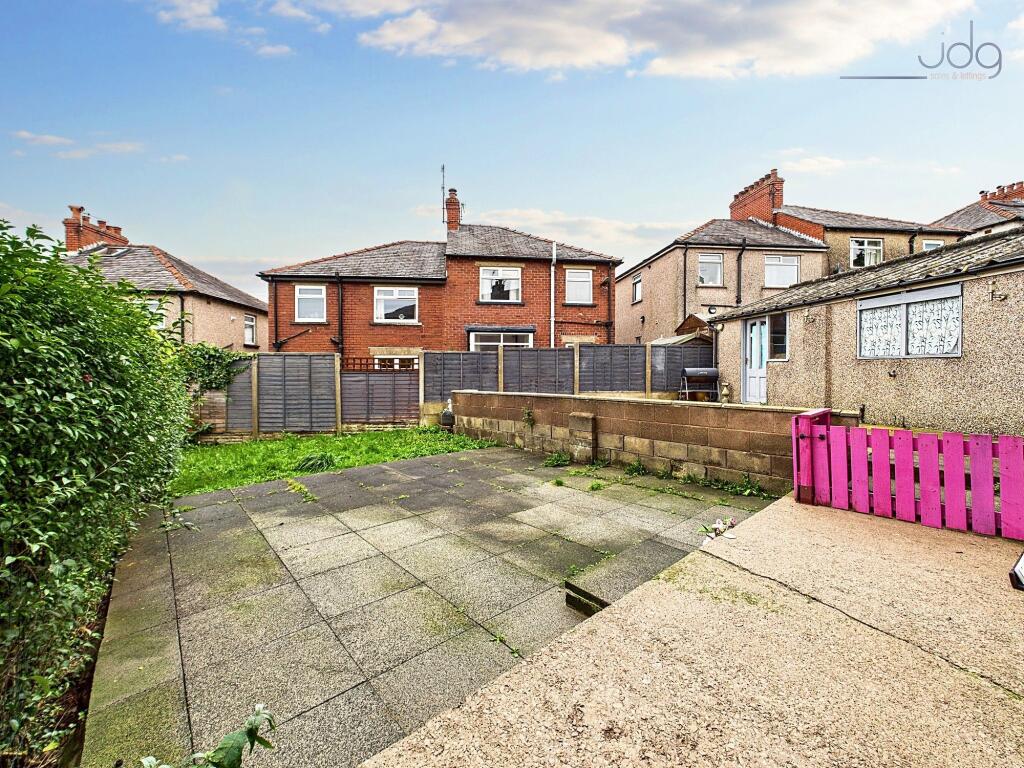 Spacious Garden with a mixture of flags and green grass