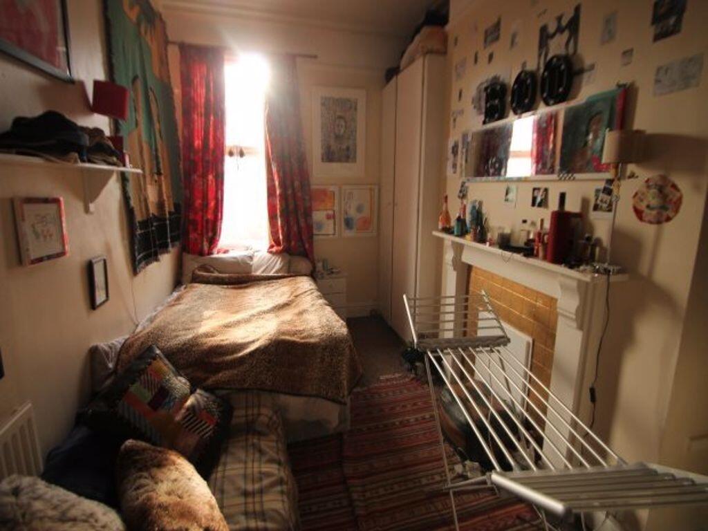 Cozy single bedroom with a warm and inviting at...