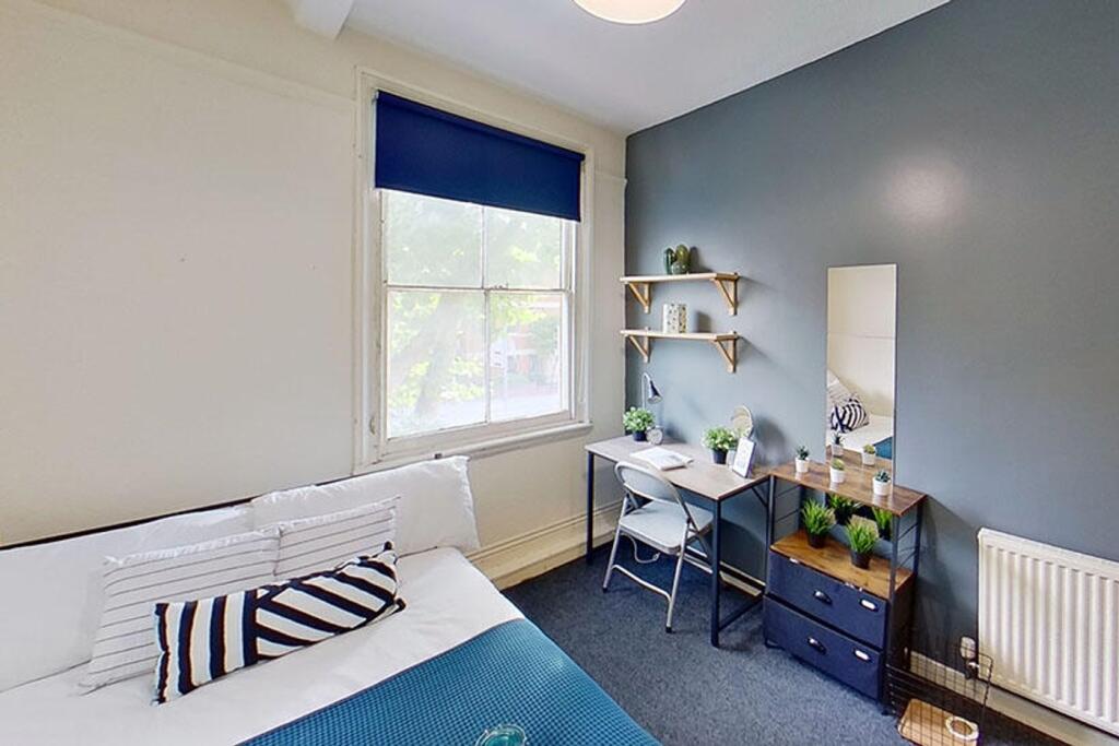 This inviting double bedroom features a cozy la...