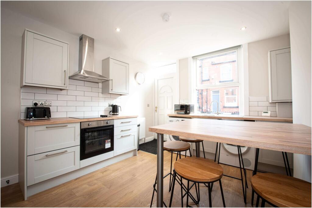 Bright and modern kitchen with ample natural li...