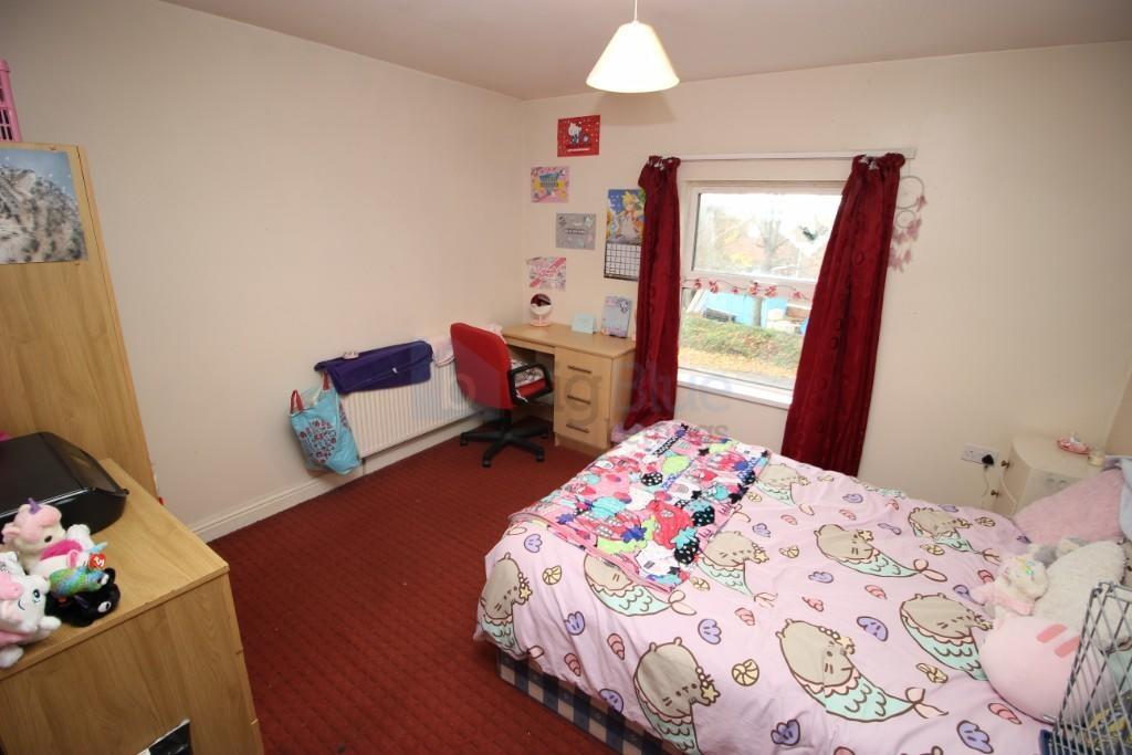 Cozy single bedroom featuring a comfortable bed...