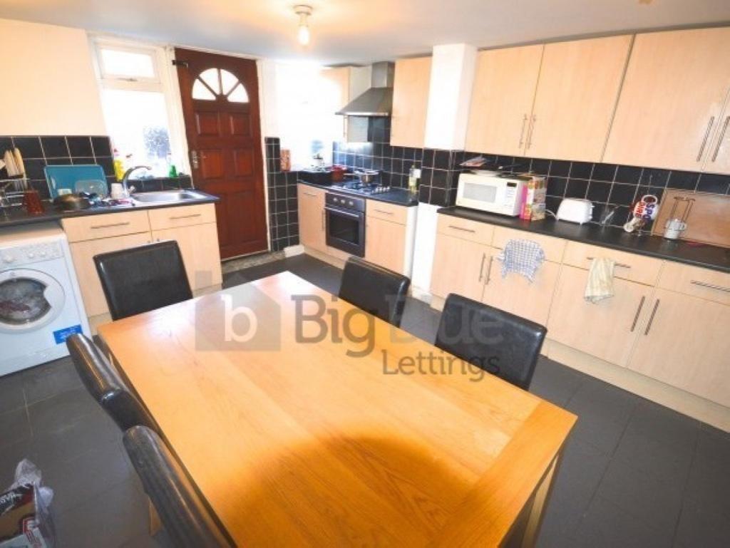 Bright and modern kitchen featuring ample cabin...