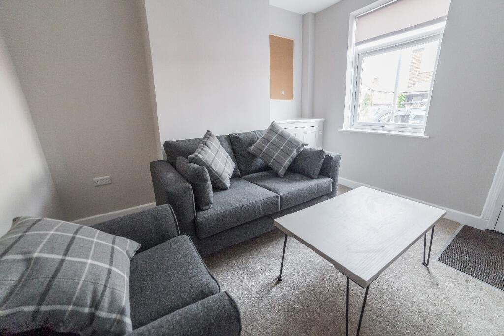This inviting living room features cozy furnish...