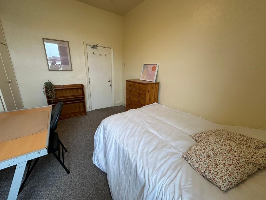 A cozy, well-maintained bedroom featuring a com...