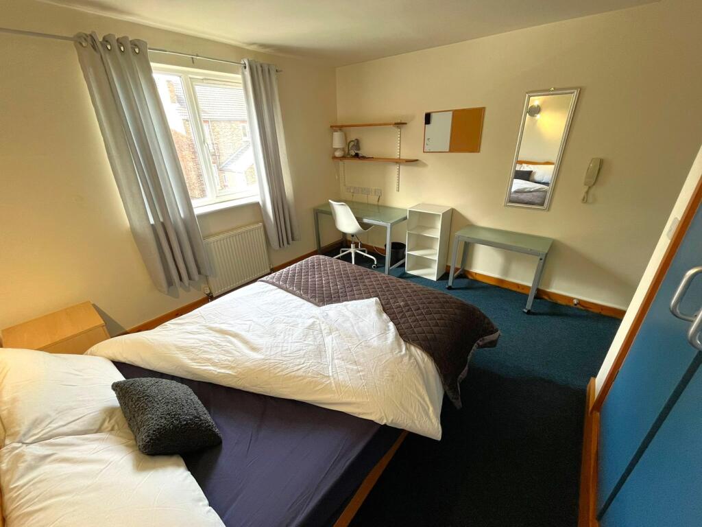 A bright and spacious double bedroom featuring ...