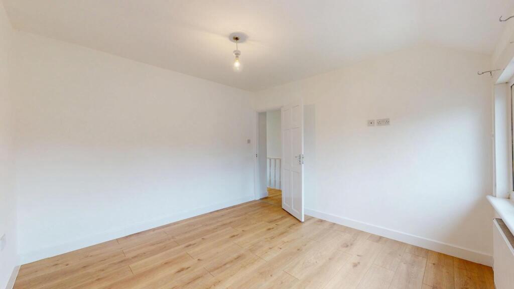 Bright and spacious living area with large wind...