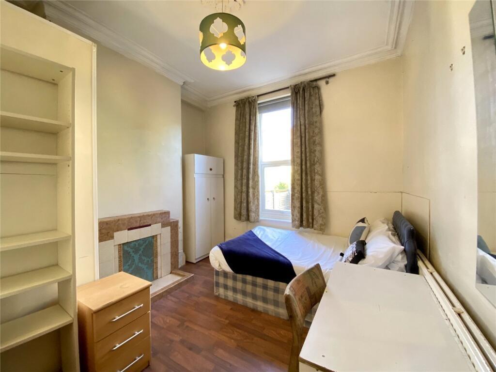 A cozy single bedroom featuring a comfortable b...