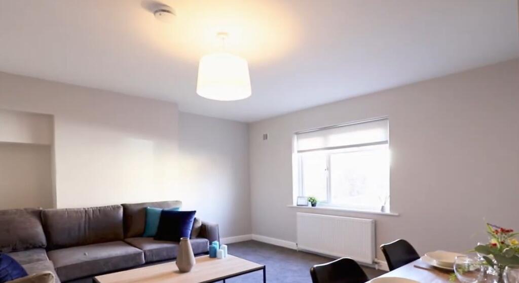 A bright and welcoming living room featuring a ...