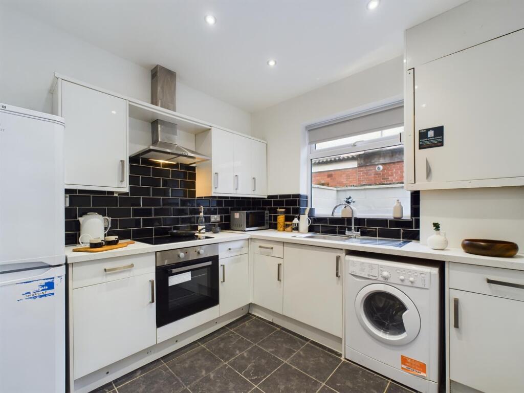 A modern and tidy kitchen with ample storage an...