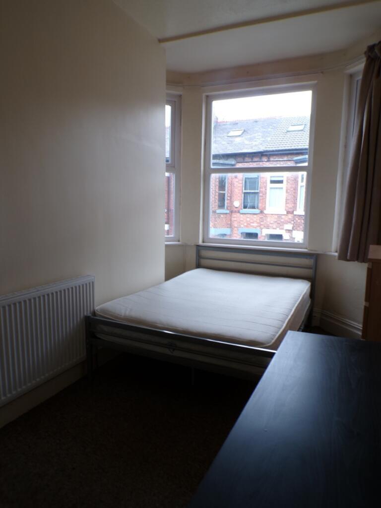 This inviting double bedroom features large win...