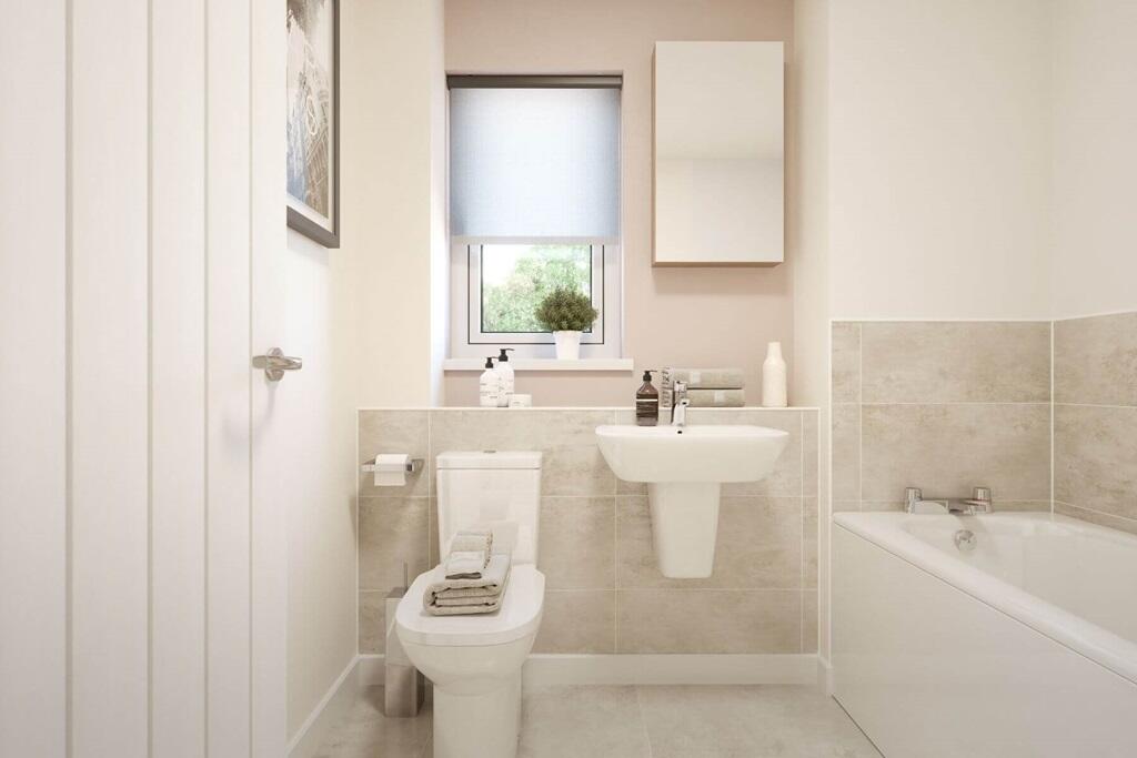 A modern bathroom featuring a shower over the bath, combining style and practicality