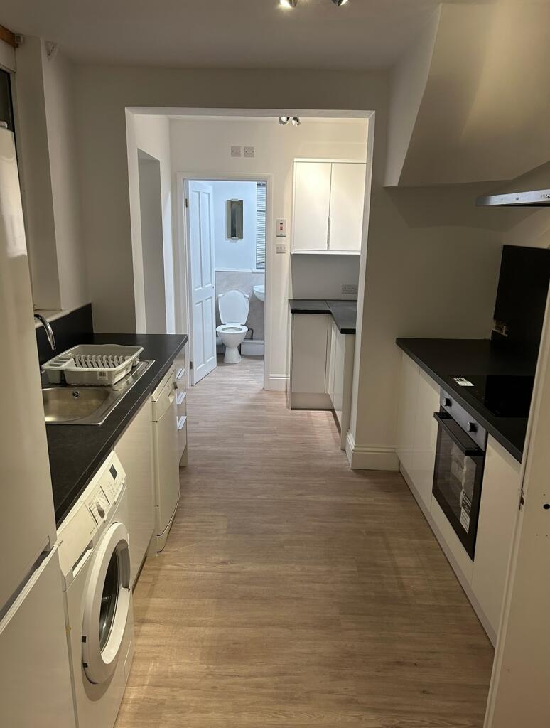 A modern and spacious kitchen with ample natura...