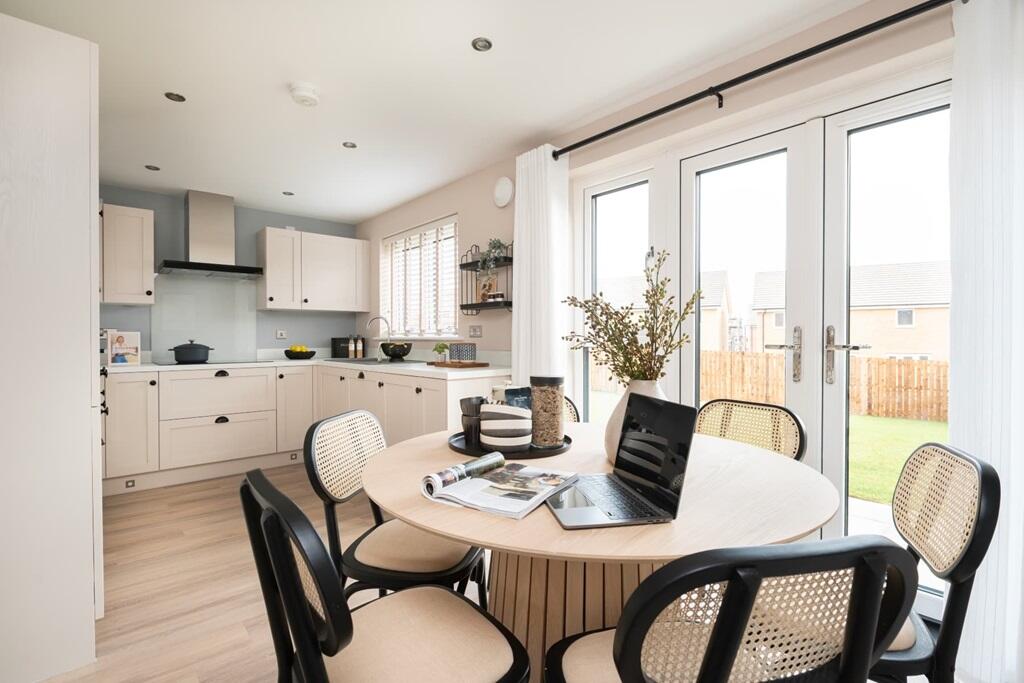 A modern kitchen and dining area with French doors to the rear garden