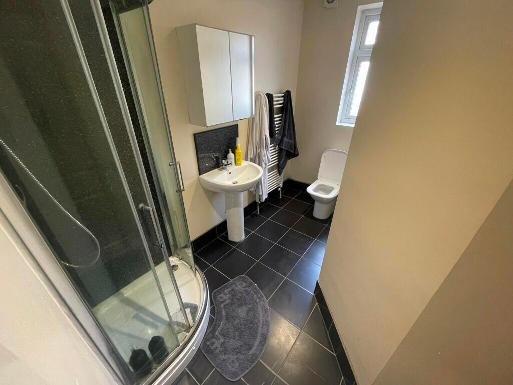 A clean and modern bathroom featuring a curved ...