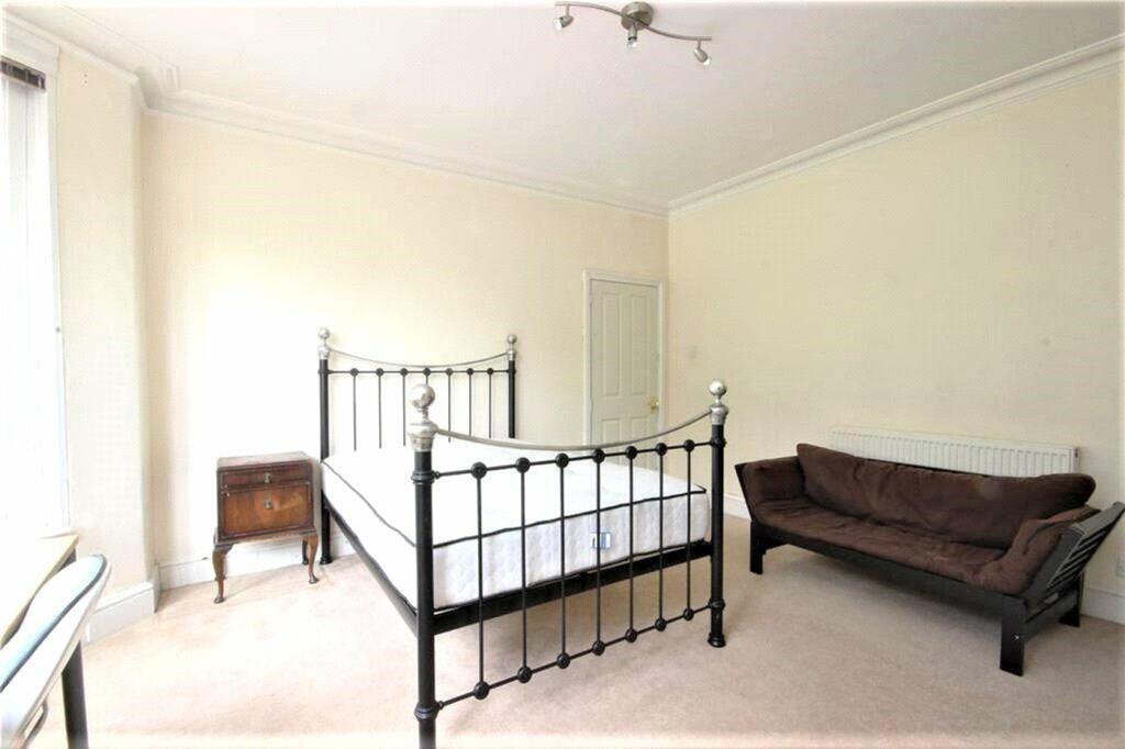 Spacious double bedroom featuring a charming ir...