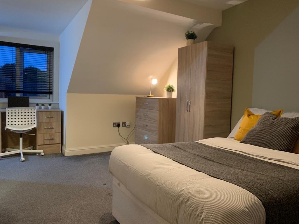 A cozy and well-maintained master bedroom featu...
