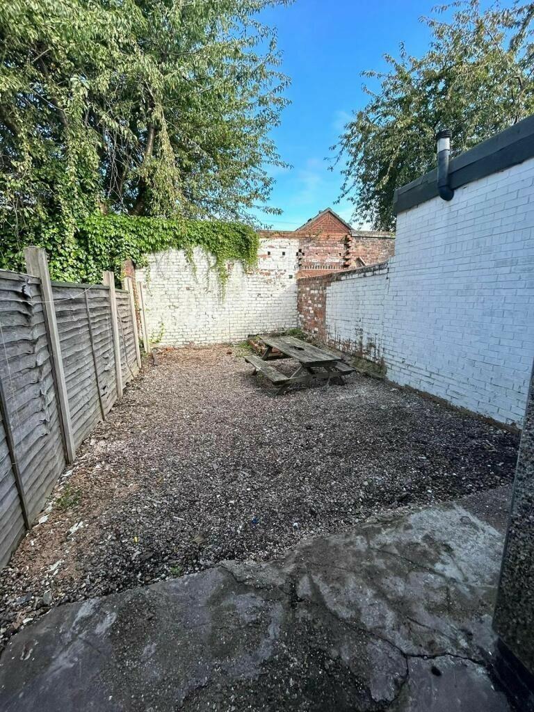 A private outdoor garden space featuring a picn...