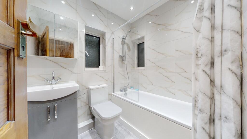 A modern and well-maintained bathroom suite fea...