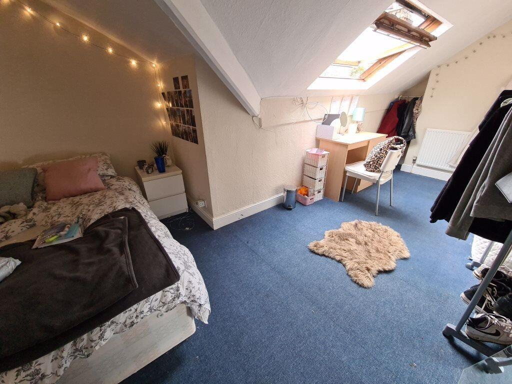 A cozy bedroom with a bed, some furniture, and ...