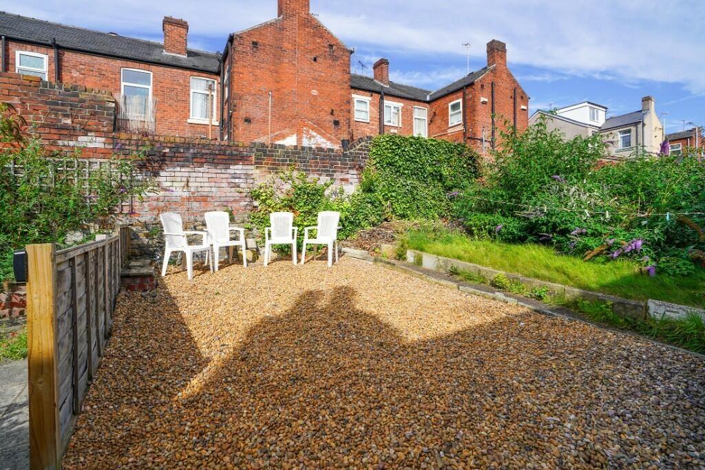 A sunny, well-maintained garden space featuring...