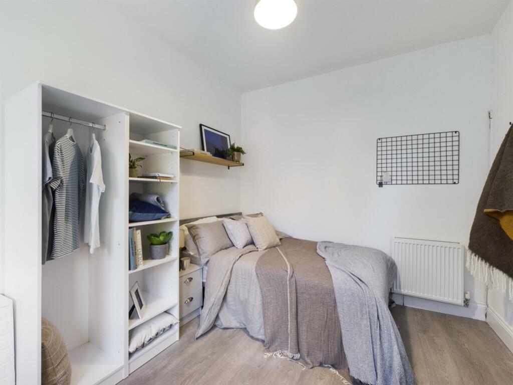 A stylish and tidy double bedroom featuring amp...