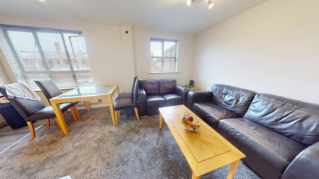 A bright and inviting living room featuring com...