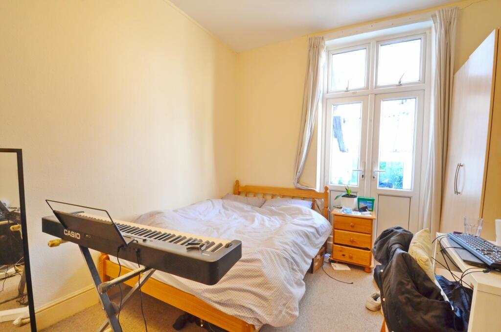 Bright and cozy bedroom featuring a large windo...