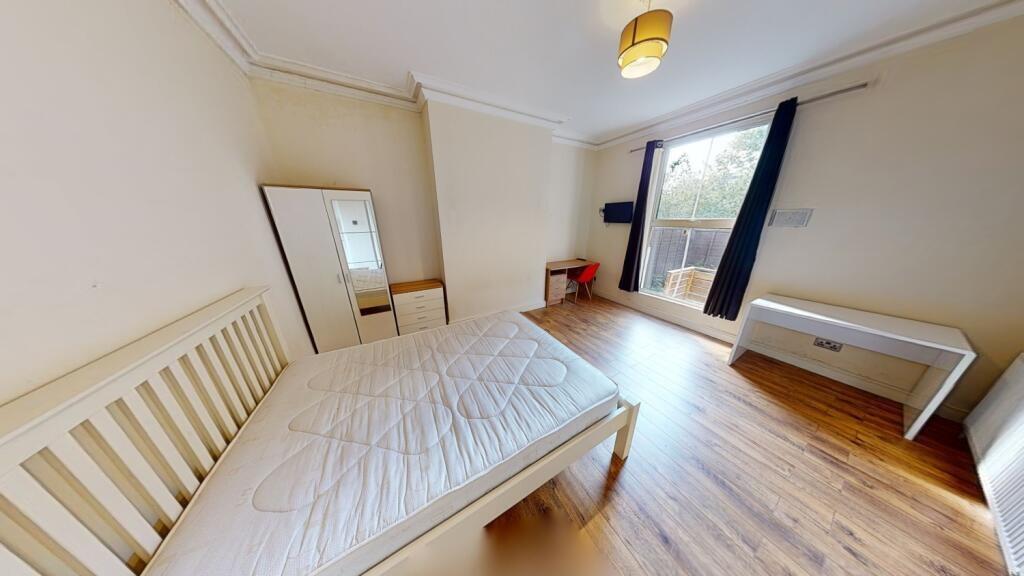 Bright and airy double bedroom featuring a larg...