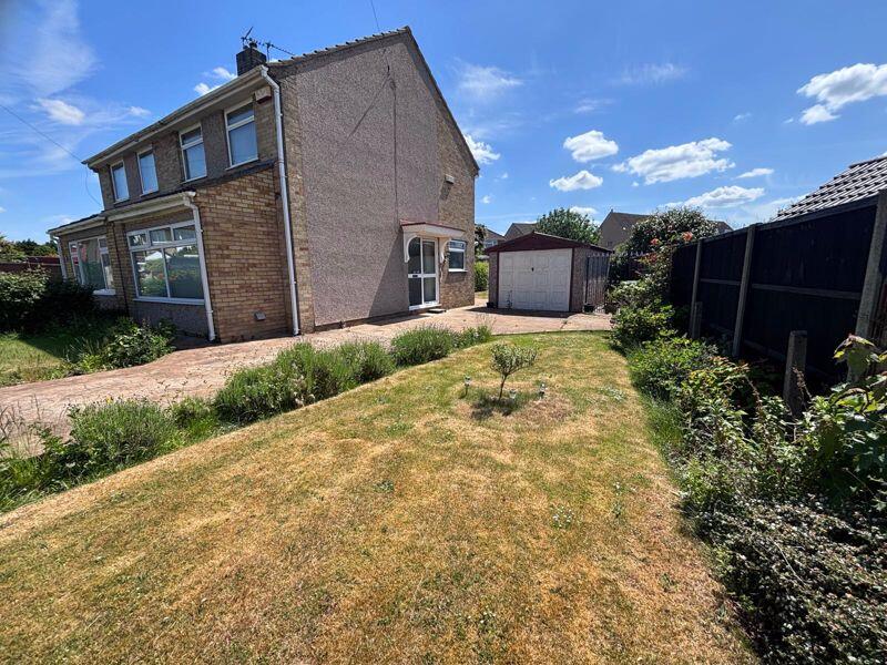 side garden, driveway and garage