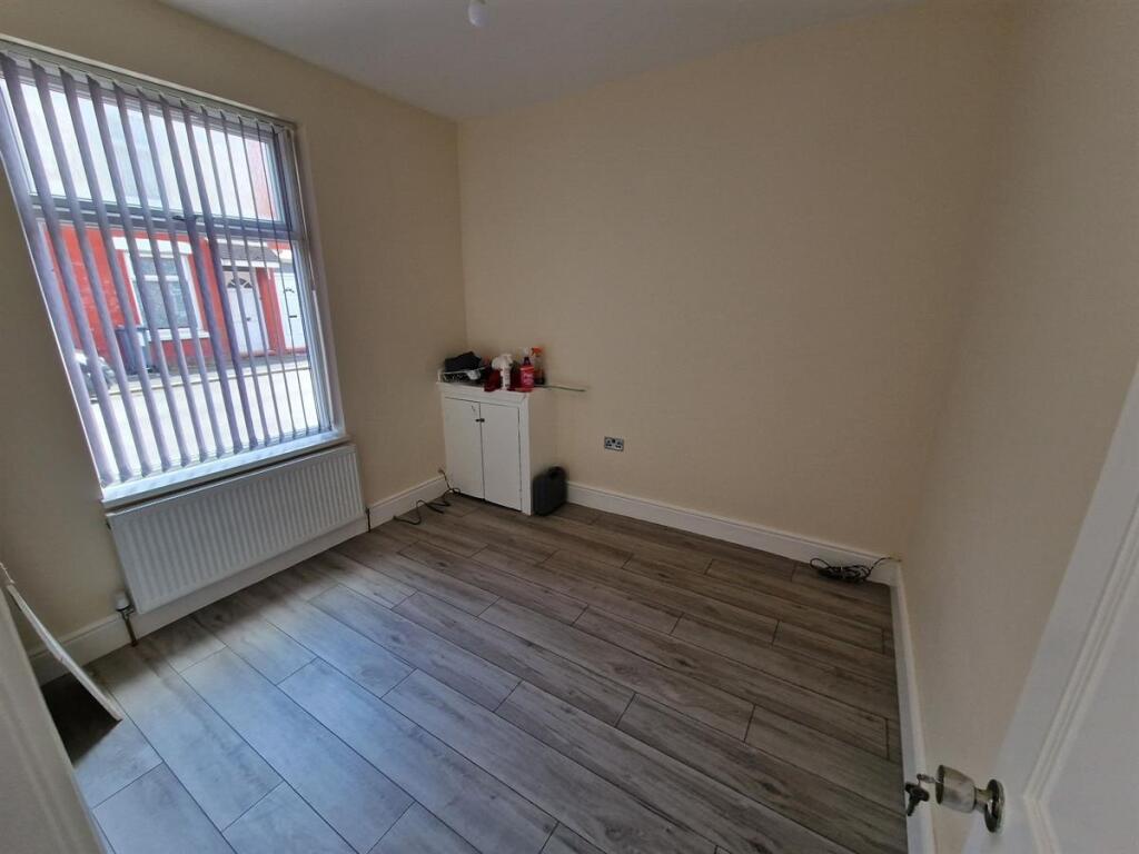 A clean, simple single bedroom featuring a larg...