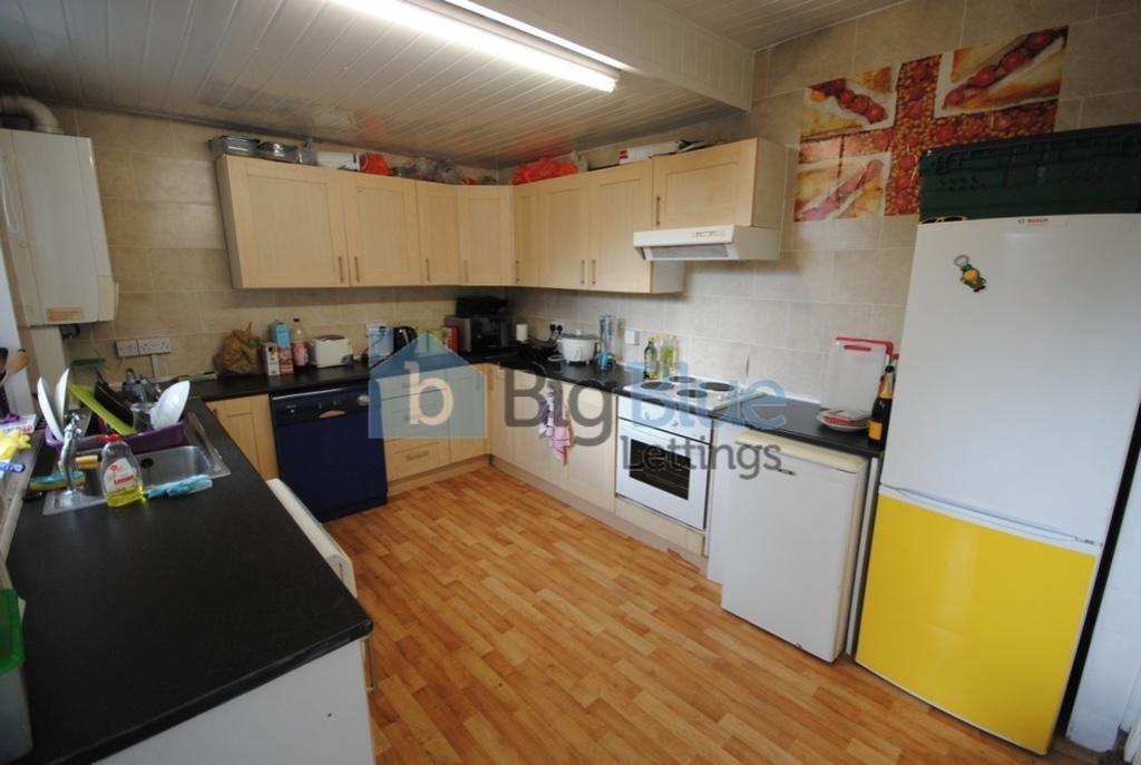 A bright and spacious kitchen featuring ample c...
